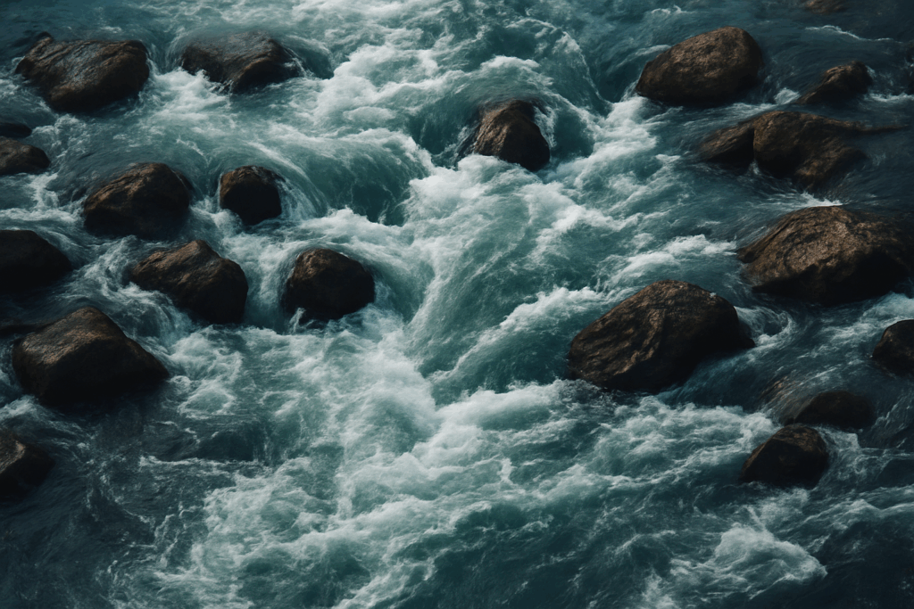 A turbulent river with rocks and swirling water symbolising disruption and the loss of rhythm after organisational change.